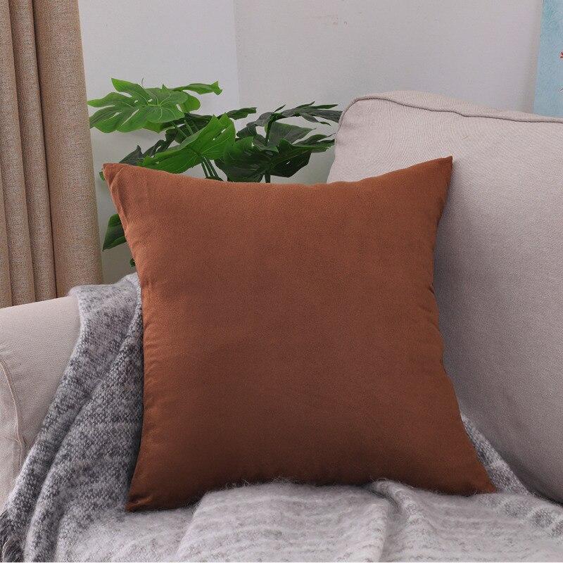 Housses de coussin extensibles 45×45, lot de 2, Terracotta, posée sur un canapé
