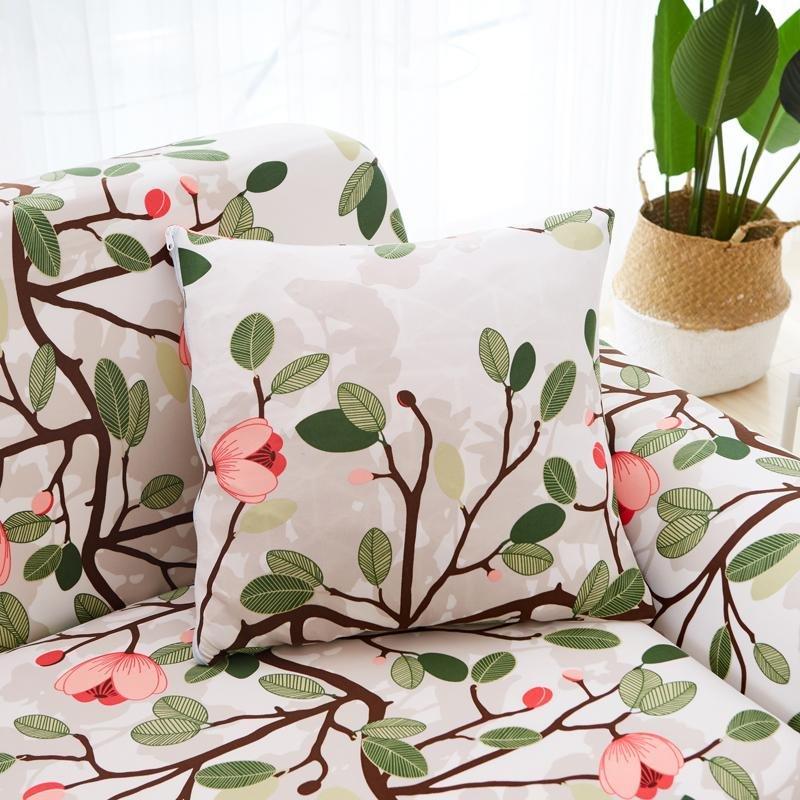 Housse de coussin extensible 45×45, à l'unité, Écru fleuri rose, posée sur un canapé