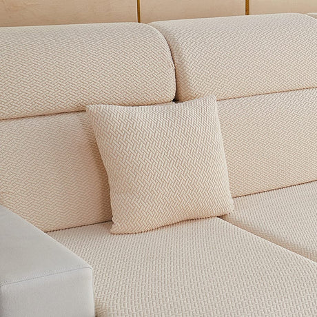 Housse de coussin polaire 45×45, à l'unité, Beige natté, posée sur un canapé