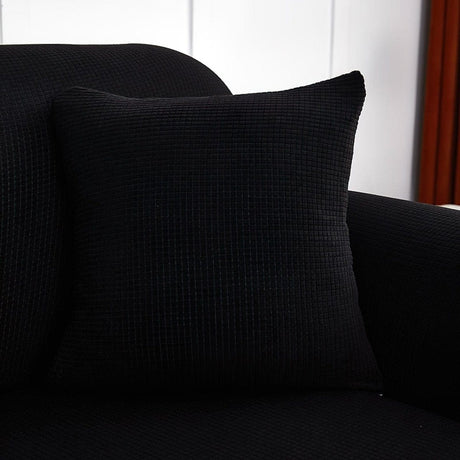 Housse de coussin déperlante 45×45, à l'unité, Noir, posée sur un canapé