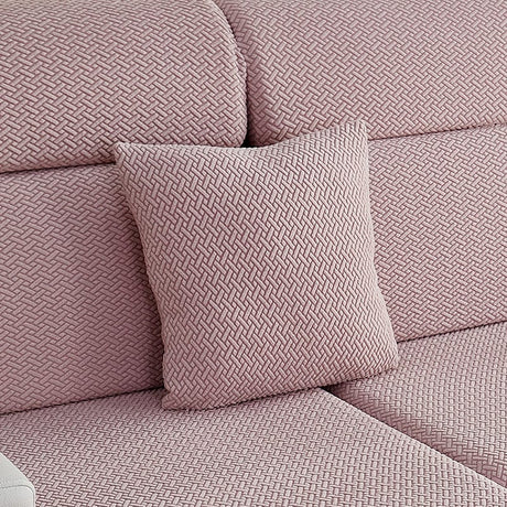 Housse de coussin polaire 45×45, à l'unité, Rose poudré natté, posée sur un canapé