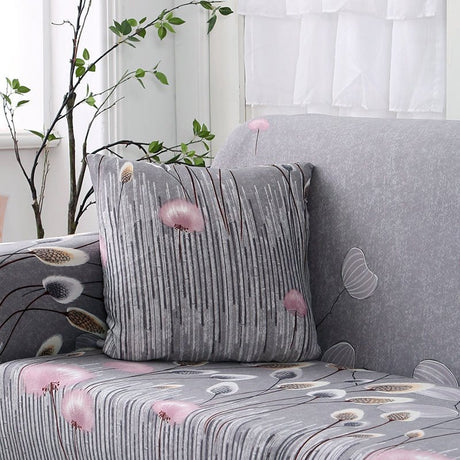 Housses de coussin déperlantes 45×45, lot de 2, Gris pompons roses, posée sur un canapé